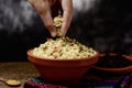 Young man eating tabbouleh with his hand