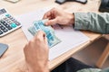 Young man ecommerce business worker counting brazil real banknotes at office