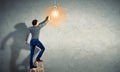 Young man with an electric light bulb Royalty Free Stock Photo