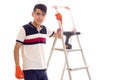 Young man with electric screwdriver and ledder