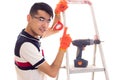 Young man with electric screwdriver and ledder