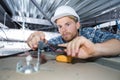 young man electrician wiring inside ceiling Royalty Free Stock Photo