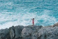 Young man embracing the ocean while standing on the cliff Royalty Free Stock Photo