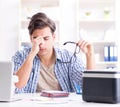 Young man employee working at copying machine in the office Royalty Free Stock Photo