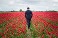 Young man is enjoying flower fields in Holland