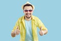 Happy cheerful man who is enjoying his summer holiday smiles and gives thumbs up Royalty Free Stock Photo