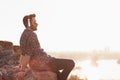 Young man listening to the music on headphones in sunset Royalty Free Stock Photo