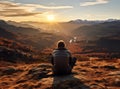 A young man enjoying looking at the stunning scenery on the high mountain before sunset.