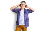 Young man enjoying music in headphones over white