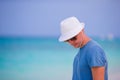 Young man enjoying the music on white sandy beach. Happy tourist relaxing on summer tropical vacation. Royalty Free Stock Photo