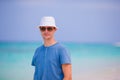Young man enjoying the music on white sandy beach. Happy tourist relaxing on summer tropical vacation. Royalty Free Stock Photo
