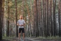 Young man enjoying the nature during a rest at jogging in the forest. Royalty Free Stock Photo