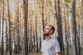 Young man enjoying the nature during a walk or jogging in the forest. Royalty Free Stock Photo