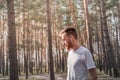 Young man enjoying the nature during a walk or jogging in the forest. Royalty Free Stock Photo