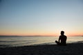 Young man enjoying sunset on the beach Royalty Free Stock Photo