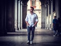 Young man in European city street walking Royalty Free Stock Photo