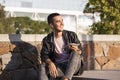 Young man excited listening music at the tablet on the stairs Royalty Free Stock Photo