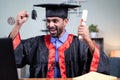 Young man excited over announcing graduation names over video call while holding certificate - concept virtual Royalty Free Stock Photo