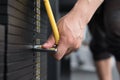 young man execute exercise with pull down machine in fitness center. male athlete select weight for training in gym. sporty guy w Royalty Free Stock Photo