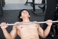 young man execute exercise with weightlifting machine in fitness center. male athlete pump up muscle in gym. sporty guy working ou Royalty Free Stock Photo