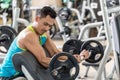 Young man exercising bicep curls with the E-Z barbell Royalty Free Stock Photo