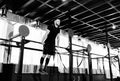 Young man exercising on horizontal bar in the gym. Male adult working out triceps and biceps on horizontal bar as cross fit train.