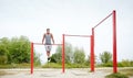 Young man exercising on horizontal bar outdoors Royalty Free Stock Photo