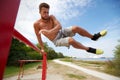 Young man exercising on horizontal bar outdoors Royalty Free Stock Photo