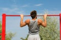 Young man exercising on horizontal bar outdoors Royalty Free Stock Photo