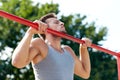 Young man exercising on horizontal bar outdoors Royalty Free Stock Photo