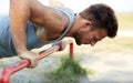 Young man exercising on horizontal bar outdoors Royalty Free Stock Photo