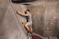 Young man exercising at indoor climbing gym Royalty Free Stock Photo