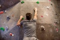 Young man exercising at indoor climbing gym wall Royalty Free Stock Photo