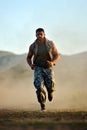 Young man exercising outdoor on dusty field Royalty Free Stock Photo