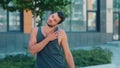 Young man exercising outside. Video process of guy warming up his body before training. Prerapation for hard intensive Royalty Free Stock Photo