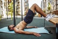 Young man exercising outside. Well built muscled guy stand in reverse plank position with legs up. Holding hands on Royalty Free Stock Photo