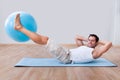 Young man exercising on a pilates ball Royalty Free Stock Photo