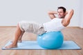 Young Man Exercising On A Pilates Ball Royalty Free Stock Photo