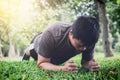 Young man exercising workout fitness doing planking outside on g Royalty Free Stock Photo