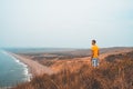 Young man exploring California by the ocean at Point Reyes cliffs. Royalty Free Stock Photo