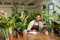 Young man in eyeglasses working in the flower shop and looking busy Royalty Free Stock Photo