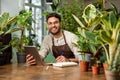 Young man in eyeglasses working in the flower shop and looking busy Royalty Free Stock Photo