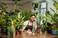Young man in eyeglasses working in the flower shop and looking busy Royalty Free Stock Photo