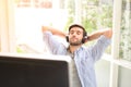 A young man  eyes closed, listening to music using headphones Royalty Free Stock Photo