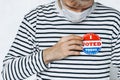 Young man in face medical mask wearing on shirt I VOTED TODAY pin. election day on coronavirus pandemic. November elections in the Royalty Free Stock Photo