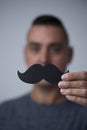 Young man with a fake moustache Royalty Free Stock Photo