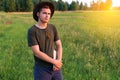 Young man farmer in cowboy hat at agricultural field on sunset holding tablet. Male on nature background, outdoors in Royalty Free Stock Photo