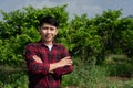 Man farmer smiling and standing in custard apple trees orchard background Royalty Free Stock Photo