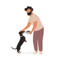 Young man feeding dog and petting on his head Royalty Free Stock Photo