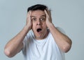 Portrait of a young man looking scared and shocked. Human expressions and emotions Royalty Free Stock Photo